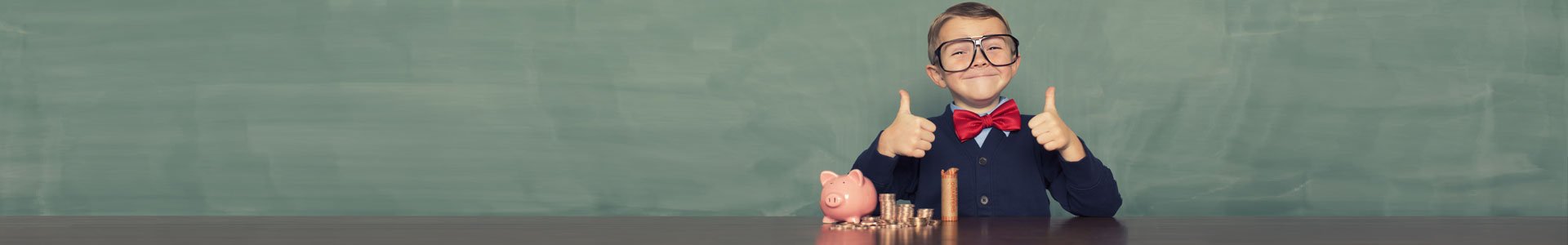 young boy smiling with piggy bank